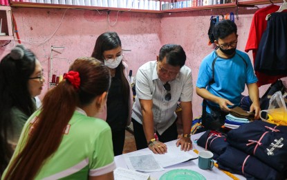 <p><strong>CONSULTATION.</strong> Reynaldo Galupo (4th from left), Presidential Commission for the Urban Poor Commissioner in-Charge for the National Capital Region, discusses plans for the livelihood projects of Barangay Sauyo residents in Quezon City in this undated photo. The agency vowed to bring government services closer to the marginalized and underprivileged sectors. <em>(Courtesy of PCUP-PIO)</em></p>