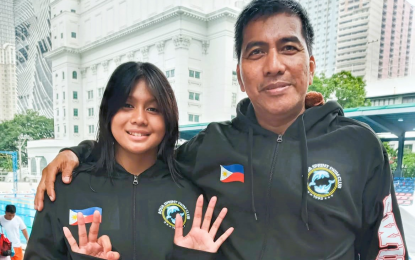 <p><strong>TRIPLE-GOLD WINNER.</strong> Aqua Sprint Swim Club head coach Manuel Thruelan (right) with one of his swimmers, triple-gold winner Paulene Beatrice Obebe during the Grand Reunion Swim Challenge Championships at the Teofilo Ildefonso pool inside the historic Rizal Memorial Sports Complex on Sunday (Nov. 13, 2022). Thruelan’s son Arbeen Miguel and Nicola Queen Diamante also pocketed three golds each. <em>(Contributed photo)</em></p>