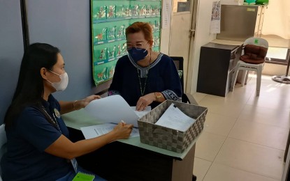 <p><strong>PBRAP</strong>. Iloilo City Local Civil Registrar Registration Officer II Marivel Gargalicana confers with Acting City Civil Registrar Cherie Ampig about the implementation of the Philippine Identification System (PhilSys) Birth Registration Assistance Project in Iloilo City Monday (Nov. 14, 2022). Gargalicana said an Ati community in Barangay Lanit Jaro is the first recipient of the program in Iloilo City. <em>(PNA photo by PGLena)</em></p>
<p> </p>