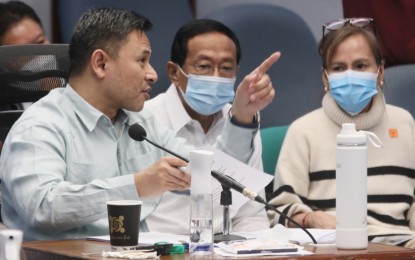 <p><strong>DELIBERATION.</strong> Senator Sonny Angara (left), Finance committee chair, defends the proposed PHP737.36 billion budget of the Department of Public Works and Highways as Secretary Manuel Bonoan (center) listens on Tuesday (Nov. 15, 2022). Among the agency’s programs are traffic decongestion, integrated and seamless transport system, sustainable communities and rural roads’ development. <em>(PNA photo by Avito Dalan)</em></p>