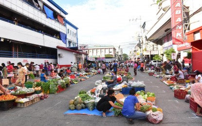<p><strong>OPEN MARKET</strong>. Vendors sell produce at an open-air market in Laoag City in this undated photo. Marketgoers in the city have been advised to bring their own eco-bags after a local ordinance has regulated single-use plastic materials. <em>(Contributed)</em></p>