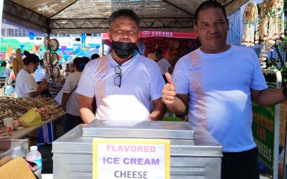 <p><strong>SUCCESS STORY.</strong> The Verseles brothers, Virgilio (left) and Fernando (right), in front of their booth at the Sustainable Livelihood Program trade fair in Urdaneta City on Nov. 16, 2022.  The brothers are members of the Bani Delicious Ice Cream association in Bayambang town, Pangasinan. <em>(Photo by Hilda Austria)</em></p>