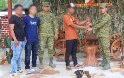 <p><strong>RIGHT MOVE. </strong> Three members of the outlawed Bangsamoro Islamic Freedom Fighters surrender in Maguindanao on Thursday (Nov. 17, 2022), as the Army’s 6th Infantry Division intensifies its manhunt against lawless elements in its area of responsibility. The surrenderers say they want to live normal lives again with their families. <em>(Photo courtesy of 6ID)</em></p>