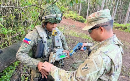 <p><strong>HAWAII WAR GAMES.</strong> A US Army Observer, Controller-Trainer (OC-T) team member checks the combat simulator gear worn by a Filipino soldier during the month-long Joint Pacific Multinational Readiness Center Exercise at Oahu's East Range in Hawaii. The Philippine Army on Friday (Nov. 18, 2022) said the exercise, which ran from October 20 to November 16, bolstered its interoperability with its American counterparts. <em>(Photo courtesy of Philippine Army)</em></p>