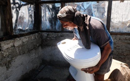 <p><strong>SANITATION.</strong> A man carries a toilet bowl to rebuild a restroom destroyed by Typhoon Odette in Limasawa, Southern Leyte in late 2021. About 24 percent of the over 1 million households in Eastern Visayas have no toilets based on the latest monitoring report of the Department of Health regional office. <em>(Photo courtesy of Unicef)</em></p>