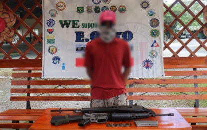 <p><strong>GAME OVER.</strong> A New People’s Army rebel, “Ka Balong”, surrenders to the Philippine Army in Barangay Calabuanan, Baler, Aurora on Sunday (Nov. 20, 2022). He said he is tired of always hiding and wants to start a new life with his family. <em>(PNA photo by Jason de Asis)</em></p>