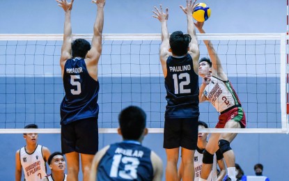 <p><strong>BATTLE FOR 9TH SPOT.</strong> University of the Philippines player Louis Gaspar Gamban tries to score against Mark Kenneth Paulino of Adamson University during their match in the classification round of the 2022 V-League Men’s Collegiate Challenge at the Paco Arena in Manila on November 20, 2022. UP won, 25-15, 25-19, 25-23, to finish ninth. <em>(Photo courtesy of PVL Media Bureau)</em></p>