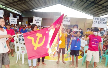 <p><strong>WITHDRAWAL OF SUPPORT.</strong> Replica flags of the Communist Party of the Philippines-New People’s Army are burned by residents of Barangay Carabalan in Himamaylan City, Negros Occidental during an indignation rally at the village gymnasium on Saturday (Nov. 19, 2021). Affected by a series of armed encounters last month, they withdrew support from the communist-terrorist group. <em>(Courtesy of 94th Infantry Battalion, Philippine Army)</em></p>