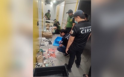 <p><strong>BUSTED.</strong> Members of the Customs Intelligence and Investigation Service account for the contraband found during a raid at a warehouse in Taguig City on Tuesday night (Nov. 22, 2022). The operation yielded cocaine with an estimated street value of PHP2.65 million, as well as kush and vape cartridges with suspected marijuana oil. <em>(Photo courtesy of BOC-CIIS)</em></p>
