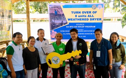 <p><strong>SUPPORT TO COFFEE GROWERS.</strong> DA-13 Regional Executive Director Ricardo Oñate Jr. (3rd from right) leads the handover of eight all-weather type dryers to Fatima Ibuan Farmers Workers Association, Inc. in Barangay Ibuan, Las Nieves, Agusan del Norte Tuesday (Nov. 22, 2022). The dryers will enhance the quality of coffee beans and help coffee farmers increase their income. <em>(Photo courtesy of DA-13 Information Office)</em></p>
