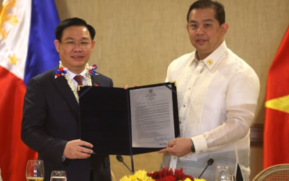 <p><strong>STRONGER TIES</strong>. House of Representatives Speaker Martin G. Romualdez (right) hands over to visiting Vietnam National Assembly Chairman Vuong Dinh Hue a copy of House Resolution 34 during the latter's official visit at the House on Wednesday (Nov. 23, 2022). The resolution seeks to further strengthen long-standing Philippine-Vietnam ties through the continuation of the exchange of visits by their respective parliamentarians.<em> (Photo courtesy of the Office of the Speaker)</em></p>