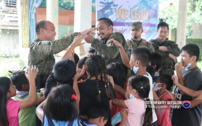 <p><strong>PROTECTING CHILDREN</strong>. Soldiers distribute goodies during an outreach activity in a remote village in Las Navas, Northern Samar in this undated photo. The Philippine Army on Thursday (Nov. 24, 2022) renewed its call to the New People’s Army to stop engaging minors in their armed struggle against the government. <em>(Photo courtesy of Philippine Army)</em></p>