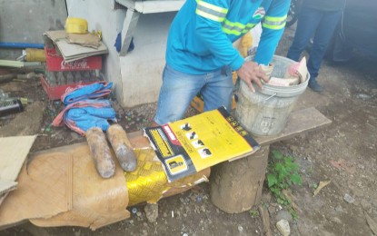 <p><strong>VINTAGE BOMBS.</strong> Two of the five vintage bombs are discovered by an excavator operator in a warehouse in Catalunan Grande, Davao City on Wednesday afternoon (Nov. 23, 2022). The police officers went to the area and discovered the unexploded ordnance, 75-mm. projectiles without a fuse, each weighing about 6 kg. <em>(Photo from Talomo police) </em></p>
