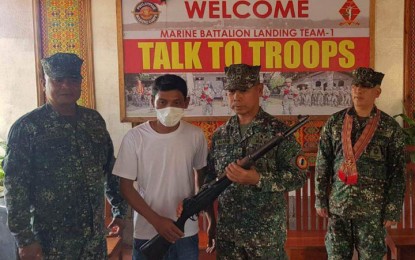 <p><strong>ASG SURRENDERERS</strong>. Brig. Gen. Romeo Racadio (2nd from right), commander of the 2nd Marine Brigade, receives a Garand rifle from one of the three Abu Sayyaf Group (ASG) surrenderers, at the headquarters of the Marine Battalion Landing Team-1 in Panglima Sugala, Tawi-Tawi on Wednesday (Nov. 23, 2022). Racadio said Friday (Nov. 25, 2022) the three ASG members decided to surrender due to the continued campaign against them in the province of Tawi-Tawi. <em>(Photo courtesy of 2nd Marine Brigade)</em> </p>
