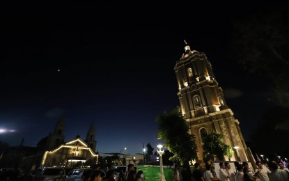 <p><strong>RESTORED</strong>. The newly-restored Jaro belfry (right) was formally turned over by the National Historical Commission of the Philippines to the Iloilo City government and the Archdiocese of Jaro in a ceremony Sunday night. The ringing of its carillon bells was again heard by Ilonggos after 74 years. <em>(PNA photo by Arnold Almacen/City Mayors Office)</em></p>