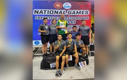 <p><strong>ARMY WRESTLERS.</strong> Wearing their medals, the Philippine Army Wrestling Team members pose for a group photo during the National Wrestling Open hosted by the Wrestling Association of the Philippines, Inc. at the Sta. Rosa Sports Complex in Laguna. Army wrestlers bested other soldier-athletes from the Philippine Navy, Philippine Air Force, as well as professional wrestlers from Singapore, Russia and the US. <em>(Photo courtesy of the Philippine Army)</em></p>