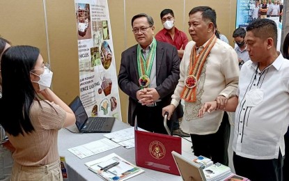 <p><strong>NEW TECHNOLOGIES</strong>. Department of Science and Technology in Central Luzon (DOST-3) Regional Director Julius Caesar Sicat and DOST Undersecretary for Regional Operations Sancho Mabborang visit the different booth exhibits showcasing the research and development innovations and technologies of various higher education institutions in the region. This is part of the four-day regional celebration of the 2022 National Science and Technology Week that kicked off on Tuesday (Nov. 29, 2022) at The Orchids Garden, City of San Fernando, Pampanga.<em> (Photo courtesy of DOST Region 3)</em></p>