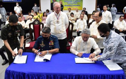<p><strong>PARTNERSHIP.</strong> Armed of the Philippines (AFP) assistant deputy chief of staff for Civil-Military Operations, Brig. Gen. Fermin Carangan (seated left), and Lions Club Multi-District 301 Philippines Council of Governors chairperson, Frederick Lim (seated right), sign a memorandum of understanding for the conduct of disaster response training, at the Bonifacio Naval Station Grandstand in Taguig City on Nov. 30, 2022. AFP Chief of Staff, Lt. Gen. Bartolome Vicente Bacarro, said the military and Lions Club International's efforts and acts of service in times of calamities and disasters have paved the way for the successful pursuit of this partnership. <em>(Photo courtesy of the Philippine Navy – Civil-Military Operations Group)</em></p>