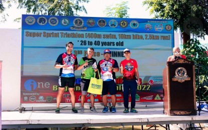 <p><strong>WINNERS.</strong> Technical Sgt. Allan P. Racines (2nd from left) receives an award after placing third runner-up in the 26- to 40-year-old age category of the Bonifacio Day "Race for our Heroes” triathlon at Sangley Point, Cavite on Nov. 30, 2022. The other Army triathletes who bagged awards during the event are Pfc. Robinson Esteves (left), Staff Sgt. Reynaldo Navarro (2nd from right), and Sgt. Lord Anthony del Rosario (right). <em>(Photo courtesy of the Philippine Army)</em></p>