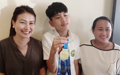 <p><br /><strong>MATH WHIZ</strong>. Gihun Ng Yoo (center), a Grade 8 learner at St. Joseph School, joined by his mother Dr. Pamela (left) and coach Irish Mae Palomo, shows the medals he won during the 12th Asian Science and Mathematics Olympiad for Primary and Secondary Schools (ASMOPSS 12) held in Bali, Indonesia from Nov. 23 to 27. In an interview Friday (Dec. 2, 2022 ) he said he feels great to bring honor to the country. <em>(PNA photo by PGLena)</em></p>