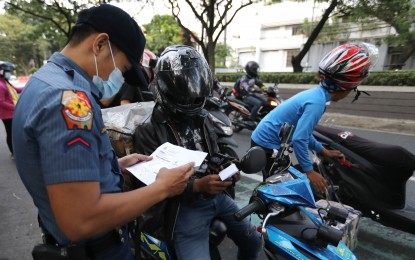 <p><strong>CHECKPOINT.</strong> A Quezon City Police District (QCPD) personnel checks the documents presented by riders along Kalayaan Avenue in Quezon City in this photo taken Dec. 4, 2022. Senator Raffy Tulfo filed a bill seeking to regulate police checkpoints in order to stop discriminatory practices and serious violations from irresponsible and abusive checkpoint personnel, especially to motorcycle riders. <em>(PNA photo by Joey O. Razon)</em></p>