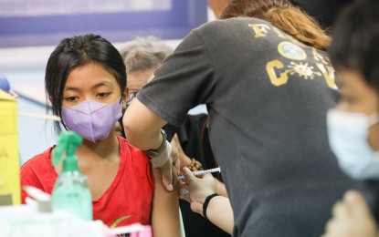 <p>A girl gets vaccinated against Covid-19. <em>(PNA photo by Yancy Lim)</em></p>