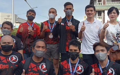<p><strong>MEDAL HAULERS.</strong> The Zamboanga City government accords recognition Monday (Dec. 5, 2022) to the medal haulers of the local delegation to the 2022 Muay Thai National Championships held from Nov. 29 to Dec. 3 in Subic, Zambales. The group was feted by Mayor John Dalipe (in white shirt) and Dr. Cecile Atilano, city sports development officer (left of Dalipe) during the flag-raising ceremony in front of city hall.<em> (Photo courtesy of Zamboanga CIO)</em></p>