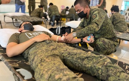 <p>A soldier donates blood during the Yuletide bloodletting drive at the Army General Hospital, Fort Bonifacio on Dec. 5, 2022. <em>(Photo courtesy of Philippine Army)</em></p>
