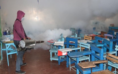 <p><strong>SWATTING OUT DENGUE</strong>. A fogging activity inside a classroom to kill mosquitoes in Maasin City, Southern Leyte in this undated photo. Dengue fever has already claimed the lives of 17 people in Eastern Visayas while 6,097 patients were sent to hospitals during the first 11 months of the year, the Department of Health (DOH) reported on Wednesday (Dec. 7, 2022). <em>(Photo courtesy of Maasin City local government)</em></p>
