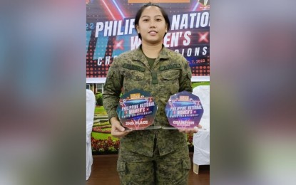 <p><strong>CHESS CHAMP</strong>. Army Woman Grandmaster (WGM) Private First Class Janelle Mae Frayna shows the two trophies she won in the 2022 National Women's Chess Championships held on Dec. 7, 2022 at the Philippine Academy For Chess Excellence (PACE) in Quezon City.<em> (Photo courtesy of PA) </em></p>