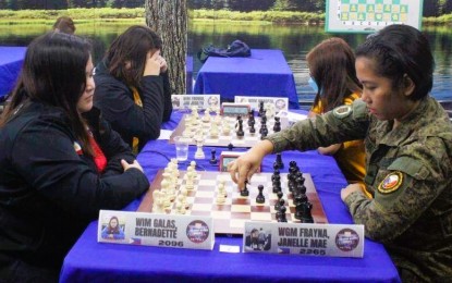 <p><strong>CHAMP.</strong> Army Woman Grandmaster Private 1st Class Janelle Mae Frayna (right) advances her move as she competes in the 2022 National Women's Chess Championships at the Philippine Academy for Chess Excellence in Quezon City on Dec. 7, 2022. Frayna is the country's first woman Grandmaster. <em>(Photo courtesy of Philippine Army)</em></p>
