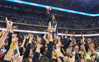 <p><strong>CHEERDANCE CHAMP.</strong> National University Pep Squad head coach Ghicka Bernabe raises the UAAP Cheerdance Competition championship trophy after the team returned to the top on Saturday, Dec. 10, 2022, at the SM Mall of Asia Arena in Pasay City. It will be Bernabe's final season as NU coach as she will get married next year. <em>(Photo courtesy of UAAP Season 85 Media Team)</em></p>