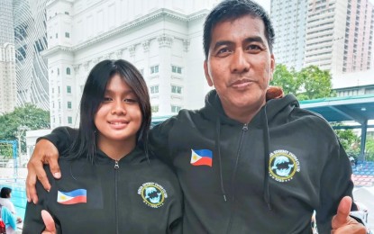 <p><strong>BEST GAL.</strong> Paulene Beatriz Obebe (left) rules the girls’ 100-meter freestyle Class A and three other 12-year-old events in the 1st Congress of Philippine Aquatics, Inc. - Samahang Manlalangoy ng Pilipinas Christmas Friendship Swimfest at Teofilo Yldefonso pool inside the Rizal Memorial Sports Complex in Malate, Manila on Sunday (Dec. 11, 2022). Also in photo is her coach of three years, Manny Thruelan. <em>(Contributed photo)</em></p>