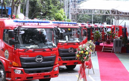 <p><strong>NEW FIRETRUCKS</strong>. The Department of the Interior and Local Government turns over 35 new fire trucks to select local government units during a ceremony at the Bureau of Fire Protection headquarters in Quezon City on Oct. 18, 2022. As of September 2023, Secretary Benjamin Abalos Jr. said 1,484 cities and municipalities already have fire stations while the agency is working to equip the remaining 150.<em> (PNA file photo by Joey O. Razon)</em></p>