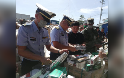 <p><strong>DESTROYED</strong>. Some PHP395 million worth of smuggled cigarettes seized by the Bureau of Customs (BOC) and other agencies of government from May to November this year is destroyed Tuesday (Dec. 13, 2022) in Barangay Baliwasan, Zamboanga City. BOC-Zamboanga district collector Segundo Sigmundfreud Barte Jr. (2nd right) said the agency would continue its anti-smuggling campaign in this part of the country. (<em>PNA photo by Teofilo P. Garcia Jr.)</em></p>