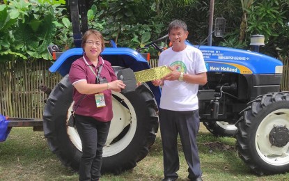 <p><strong>TURNOVER.</strong> A four-wheeled drive 35 horsepower farm tractor worth PHP1.26 million is turned over to the Hugpong Sa Nagkahiusang Mag-uuma (HUSANAMA) in Barangay Gaway-gaway, San Remigio, Northern Cebu in this undated photo. Grace Fua, Cebu Provincial Agrarian Reform Program Officer II, encouraged the group members to fully utilize the tractor to increase the organization’s farm production and income. <em>(Contributed photo)</em></p>