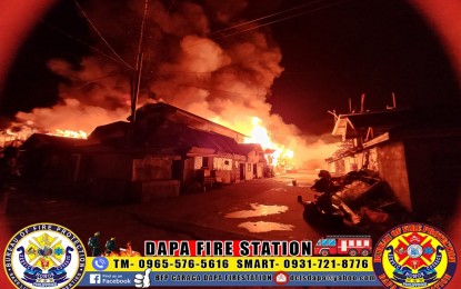 <p><strong>PREDAWN FIRE.</strong> A fire breaks out at around 12:35 a.m. Tuesday (Dec. 13, 2022) in a residential area in Barangay 13, Dapa, Surigao del Norte. Initial investigation said at least 52 houses were destroyed by the blaze that left around 74 families homeless. <em>(Photo courtesy of BFP-Dapa)</em></p>