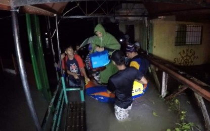 <p><strong>TYPHOON VICTIMS</strong>. A family is rescued by the Municipal Disaster Risk Reduction and Management of San Jose de Buenavista, Antique from flooding caused by Severe Tropical Storm Paeng. Pag-IBIG Antique Branch Manager Donald Alton Cahilo said Tuesday (Dec. 13, 2022) 481 borrowers who were affected by the storm had availed of the calamity loan from their office. <em>(PNA photo courtesy of San Jose de Buenavista MDRRMO)</em></p>