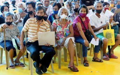 <p><strong>HEALTH INSURANCE</strong>. Senior citizens sit in line during the social pension distribution in Barangay Bahay Toro, Quezon City in this Dec 13, 2022 photo. Albay Rep. Joey Salceda said on Wednesday (April 3, 2024) he is exploring a more aggressive seniors health insurance system, particularly covering acute or catastrophic health care costs. <em>(PNA file photo)</em></p>