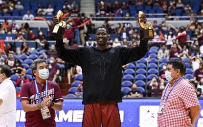 <p><strong>MVP</strong>. University of the Philippines’ student foreign athlete Malick Diouf raises both his Mythical Five and MVP trophies during the awarding ceremony before UP-Ateneo Game 2 at the Smart Araneta Coliseum in Quezon City on Wednesday (Dec. 14, 2022). The UP Fighting Maroons lead 1-0. <em>(Photo courtesy of UAAP Season 85 Media Team)</em></p>