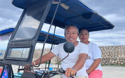 <p><strong>BETTER LIVES.</strong> Eduardo Vildosola is seen in this photo driving his tricycle with his wife, Annabelle, after attending to their fish trading business in Malabuyoc, Cebu. The Vildosola family is among the 336 beneficiaries of the Pantawid Pamilyang Pilipino Program (4Ps) of the Department of Social Welfare and Development (DSWD) who shared how the national government aid program helps their children finish college. <em>(Photo courtesy of DSWD-7)</em></p>