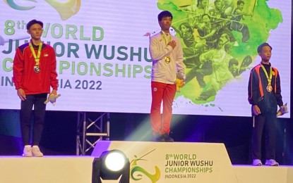 <p><strong>FINAL EVENT.</strong> Sandrex Gainsan (center) sings the national anthem after ruling the Qiangshu (spear play) event of the World Junior Wushu Championships in Tangerang, Indonesia on Dec. 10, 2022. It was the 18-year-old Gaisan’s last event in the juniors level. <em>(Contributed photo)</em></p>