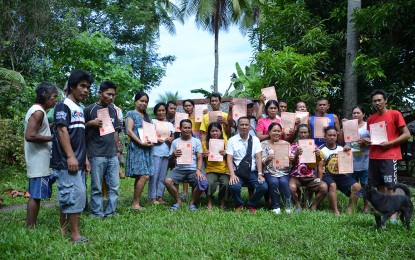 <p><strong><span data-preserver-spaces="true">NEW LANDOWNERS.</span></strong><span data-preserver-spaces="true"> The 31 farmers show their certificates of land ownership. The farm tenants, including former rebels in Calubian, Leyte received their land titles on Wednesday (Dec. 14, 2022) as an early Christmas gift from the Department of Agrarian Reform (DAR), making them owners of the land they have been tilling for decades. </span><em><span data-preserver-spaces="true">(Photo courtesy of DAR Region 8)</span></em></p>