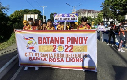 <p><strong>LET THE GAMES BEGIN.</strong> Delegates from the City of Santa Rosa, Laguna join the opening-day parade of the Batang Pinoy National Championships at the Quirino Stadium in Bantay town, Ilocos Sur province on Saturday (Dec. 17, 2022). More than 6,000 athletes are competing in nine on-site events and eight other disciplines to be conducted online. <em>(Courtesy of PIA-Ilocos Sur)</em></p>