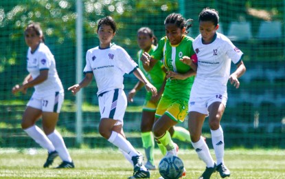 <p><strong>REMATCH.</strong> Dionesa Tolentin of Far Eastern University (in green) tries to keep the ball in play while being pressured by Cara Illeana Cachero of University of the Philippines (No. 12) during the elimination stage of the Philippine Football Federation Women's Cup in late November. FEU won, 2-0, and will try to sweep UP when they clash in the finals on Saturday (Dec. 17, 2022). <em>(Courtesy of PFF)</em></p>