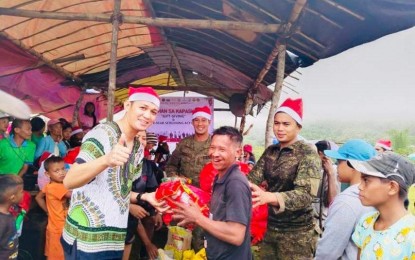 <p><strong>GIFT-GIVING</strong>. Residents of the remote Sitio Madaja in Barangay Buenavista of Himamaylan City, Negros Occidental province receive early Christmas treats during the “Bayanihan sa Kapaskuhan" gift-giving activity organized by the Philippine Army's 303rd Infantry Brigade, together with various organizations on Dec. 10, 2022. Before it became a conflict-free area, Sitio Madaja was vulnerable to the influence of the Communist Party of the Philippines-New People’s Army. <em>(Photo courtesy of 303rd Infantry Brigade, Philippine Army)</em></p>