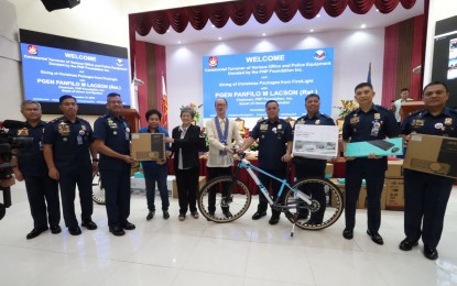 <p><strong>DONATION.</strong> PNP deputy chief for administration Lt. Gen. Rhodel Sermonia (4th from right) receives the donations from the PNP Foundation Inc. in a ceremony in Camp Crame, Quezon City on Monday (Dec. 19, 2022). The donation includes mountain bikes and office equipment such as computers, printers, projectors and a public address system.<em> (Photo courtesy of PNP)</em></p>