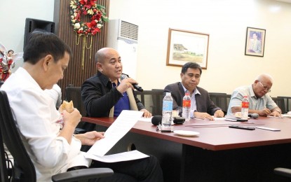 <p><strong>BUSINESS AS USUAL</strong>. Mayor Michael Rama reads a document while meeting his department heads at the Cebu City Hall in this Dec. 17, 2022 photo. Rama on Monday reassured Cebuanos that it is business as usual at the city hall despite the plunder charges filed against three of his department heads.<em> (Photo courtesy of Cebu City Hall PIO)</em></p>