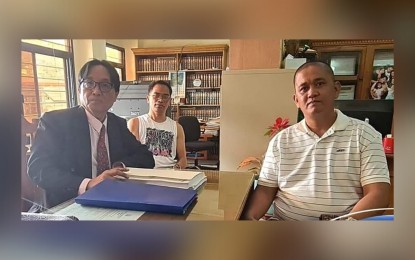 <p><strong>PROOF OF LIFE.</strong> Bureau of Corrections deputy security officer Ricardo Zulueta (right) meets with his counsel (left), Lauro Gacayan, in La Union in this undated photo posted on the lawyer’s Facebook account on Friday (Dec. 16, 2022). Gacayan shared the photo of his client, co-accused in the death of broadcaster Percival Mabasa, to prove that he is not hiding and is still alive. <em>(Courtesy of Lauro Gacayan Facebook)</em></p>