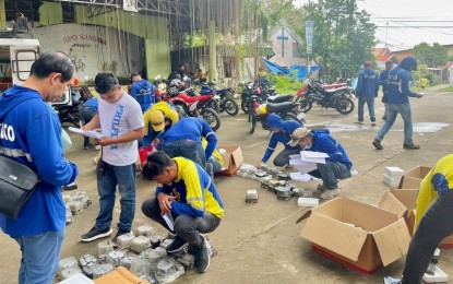 <p><strong>NEW TECH.</strong> Personnel of the Cotabato Electric Cooperative (Cotelco) Inc. verifies the uninstalled meters after the massive replacement of meters in its pilot area in Barangay Poblacion, Kidapawan City on Tuesday (Dec. 20, 2022). The power firm is set to replace the old meters with new automated meter reading devices.<em>  (Photo courtesy of Cotelco)</em></p>
